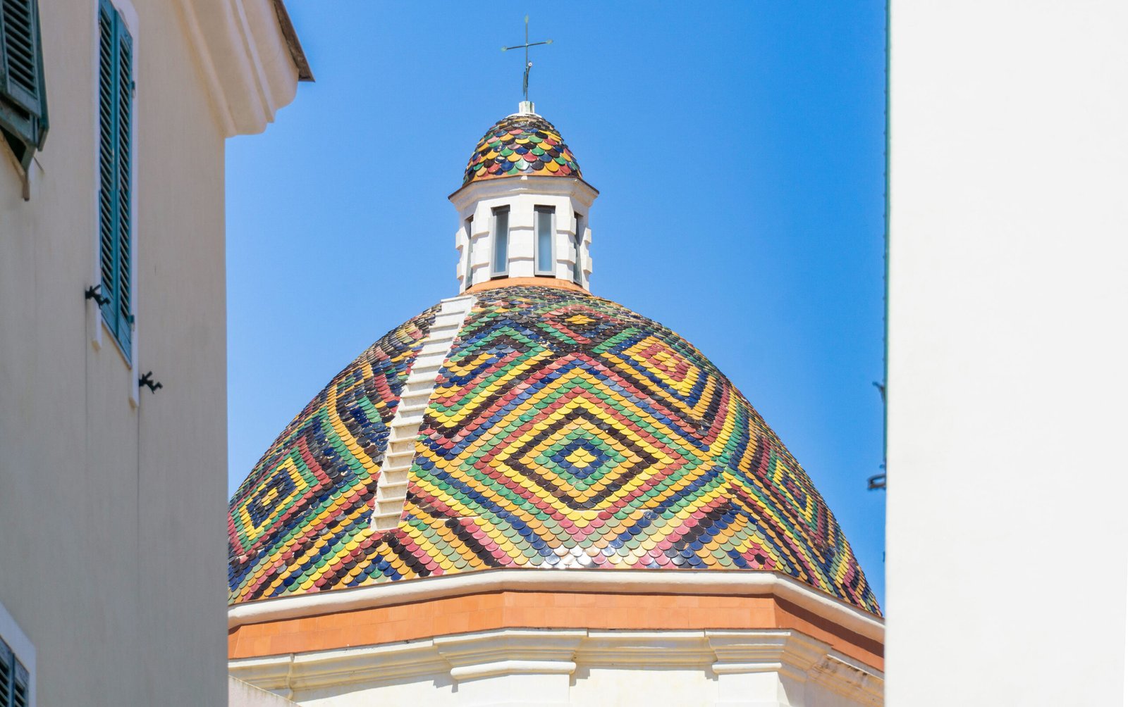 alghero-cathedral Photo by <a href="https://unsplash.com/@vincent_61?utm_content=creditCopyText&utm_medium=referral&utm_source=unsplash">VINCENZO INZONE</a> on <a href="https://unsplash.com/photos/a-dome-with-a-cross-on-top-of-it-IaQf7jzTgXk?utm_content=creditCopyText&utm_medium=referral&utm_source=unsplash">Unsplash</a>